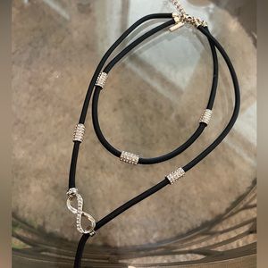 Layered necklace. Black and silver with some diamond accents.